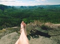 Naked hairy male legs with leather sandals rest while trail