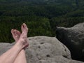 Naked hairy male legs with leather sandals rest while trail