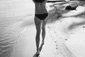 Naked lady walks along sea shore monochrome scenic photography