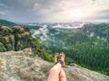 Naked legs of successful hiker on exposed sandstone rock