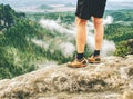 Naked legs of successful hiker on exposed sandstone rock