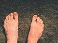 Naked male feet on dry sandstone. Fresh pink skin, shor tnails. Foot on pure nature ground Royalty Free Stock Photo