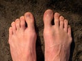 Naked male feet on dry sandstone. Fresh pink skin, shor tnails. Foot on pure nature ground Royalty Free Stock Photo