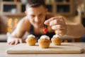 Naked man in apron cooking dessert on the kitchen Royalty Free Stock Photo