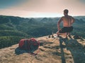 Naked man having picnic. Toples climber sit and eat sandwich