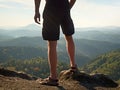Naked man stay in black pants at the top of mountain. Hiker watch the morning hilly landscape Royalty Free Stock Photo