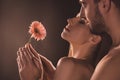 naked sensual lovers holding flower,