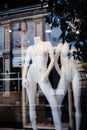 Naked silhouettes of mannequins without heads in a showcase of a modern store