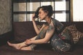 Tatoo girl on the sofa in home Royalty Free Stock Photo