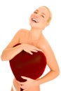 Naked woman with heart-shaped pillow Royalty Free Stock Photo