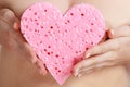 Naked woman holding pink heart sponge in hands. Royalty Free Stock Photo