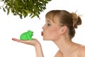 Naked woman kissing a frog under mistletoe