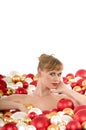 Naked woman lying surrounded by Christmas balls Royalty Free Stock Photo