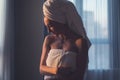 Naked woman with towel on her head and body after bath.