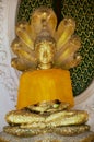 Gold covered Buddha statue at the Phra Pathon Chedi in Nakhon Pathon, Thailand.