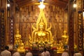 Thai Buddhists are sitting and praying front of ain Buddha inside a Church.