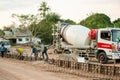 NAKHON PHANOM, THAILAND - DEC 24, 2018 : Concrete mixer truck. Workers are pouring concrete in site building construction Royalty Free Stock Photo