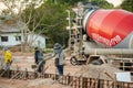 NAKHON PHANOM, THAILAND - DEC 24, 2018 : Concrete mixer truck. Workers are pouring concrete in site building construction Royalty Free Stock Photo