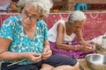 NAKHON PHANOM, THAILAND - Mar 25, 2019 : Group Senior Woman manually weaving bamboo