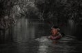 Rear view of young couple Woman and man. Adventurous people having fun together while red kayaking on brook in forest