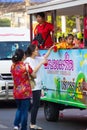 NAKHON SAWAN, THAILAND - FEBRUARY 8 : unidentified asian woman giving red soda to others on bus in Chinese New Year festival on