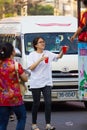NAKHON SAWAN, THAILAND - FEBRUARY 8 : unidentified asian woman giving red soda to others in Chinese New Year festival on February