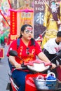 NAKHON SAWAN, THAILAND - FEBRUARY 8 : unidentified asian woman with paint on face riding a motorcycle in Chinese New Year festival Royalty Free Stock Photo