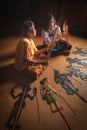 Nakhon Si Thammarat, Thailand - August 15, 2020: Senior women and Granddaughter play shadow puppet is traditional South of