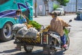 NAKHON SI THAMMARAT-THAILAND,AUGUST 30, 2000 : An unidentified elderly female vendor ride a motorcycle selling durians and fruits