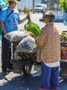 NAKHON SI THAMMARAT-THAILAND,AUGUST 30, 2000 : An unidentified elderly female vendor ride a motorcycle selling durians and fruits