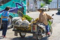 NAKHON SI THAMMARAT-THAILAND,AUGUST 30, 2000 : An unidentified elderly female vendor ride a motorcycle selling durians and fruits