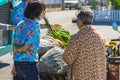 NAKHON SI THAMMARAT-THAILAND,AUGUST 30, 2000 : An unidentified elderly female vendor ride a motorcycle selling durians and fruits