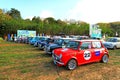 Many old Classic Mini Austin cooper parked on grass field with green tree and blue sky background Royalty Free Stock Photo