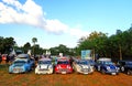 Many old Classic Mini Austin cooper parked on grass field with green tree and clear blue sky background Royalty Free Stock Photo