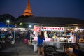 Nakorn Prathom, Thailand - April 4, 2023 : Local people walking in food truck night market in front of Phra Pathom Chedi the