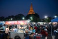 Nakorn Prathom, Thailand - April 4, 2023 : Local people walking in food truck night market in front of Phra Pathom Chedi the