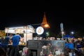 Nakorn Prathom, Thailand - April 4, 2023 : Local people walking in food truck night market in front of Phra Pathom Chedi the