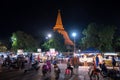 Nakorn Prathom, Thailand - April 4, 2023 : Local people walking in food truck night market in front of Phra Pathom Chedi the