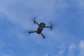 Unmanned aerial vehical with video camera hovers in the air. This is DJI Mavic Pro model. Royalty Free Stock Photo