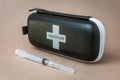 Naloxone kit and syringe front of seamless plain background
