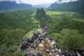 NAM XAY VIEWPOINT, VANG VIENG, LAOS - JULY 25, 2019: Ancient motorcycle parked and Lao flag on the Nam Xay Viewpoint, During the