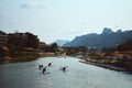 Nam Xong River surrounded by buildings and rocks under the sunlight in Vang Vieng in Laos Royalty Free Stock Photo