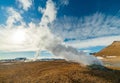 Namafjall Hverir geothermal area in Iceland. Stunning landscape of sulfur valley with smoking fumaroles and blue cloudy Royalty Free Stock Photo