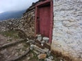 Namche Bazaar, Nepal - May 2019: small and red wooden door details during the trekking to EBC in Nepal