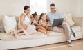Name anything you want to watch and well find it on here. a young family looking at something on a laptop while sitting Royalty Free Stock Photo