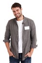 This name badge is yours to fill in. Studio portrait of a smiling young man with a blank nametag standing with his hands
