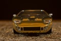Reproduction of a toy GT40 ford on a sand background