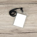 Name id card badge with cord on wooden background.