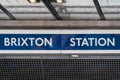 Name sign at the entrance of a Brixton London Underground station in Brixton, London, UK