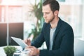 In the name of success. a successful businessman using his tablet the office. Royalty Free Stock Photo